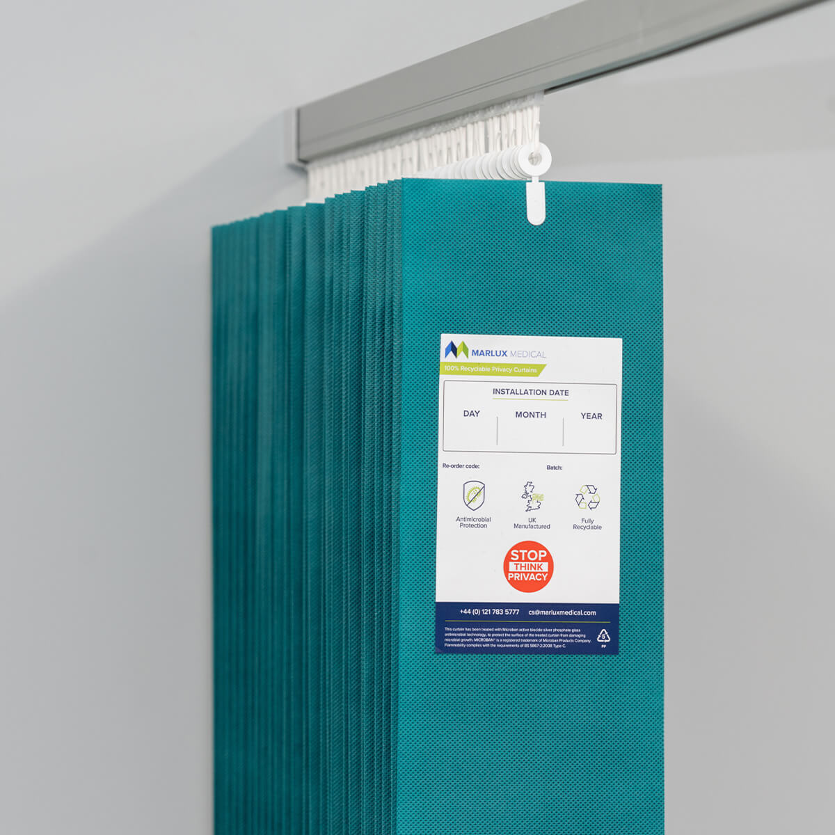 Marlux™ 4.2M forest green universal anti-bac curtain hanging on a rail, single panel, with antimicrobial fabric for hygiene.