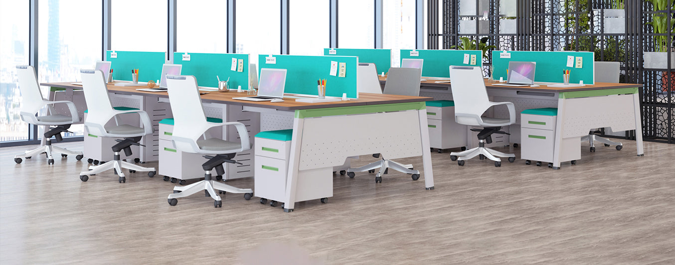 Modern open office workspace with ergonomic chairs, desks, and laptops, bright windows