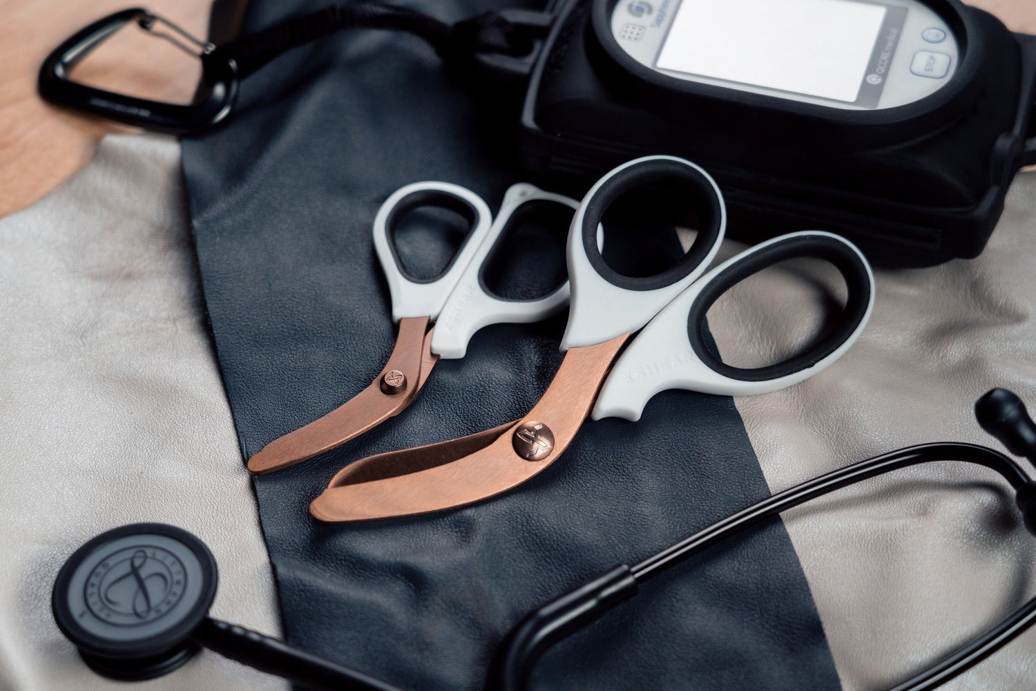 Medical shears, stethoscope, and diagnostic device on medical uniform fabric