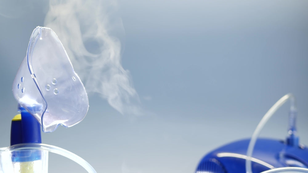 Medical nebuliser machine with mask emitting vapor for respiratory therapy
