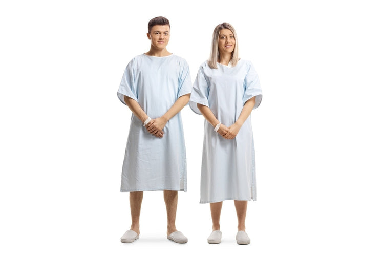 Male and female models wearing light blue patient gowns and hospital slippers
