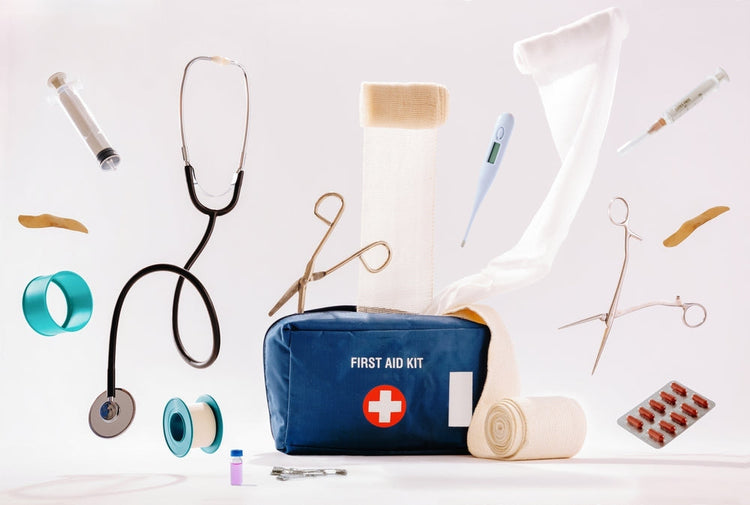 Medical first aid kit with stethoscope, bandages, syringe, scissors, thermometer and supplies