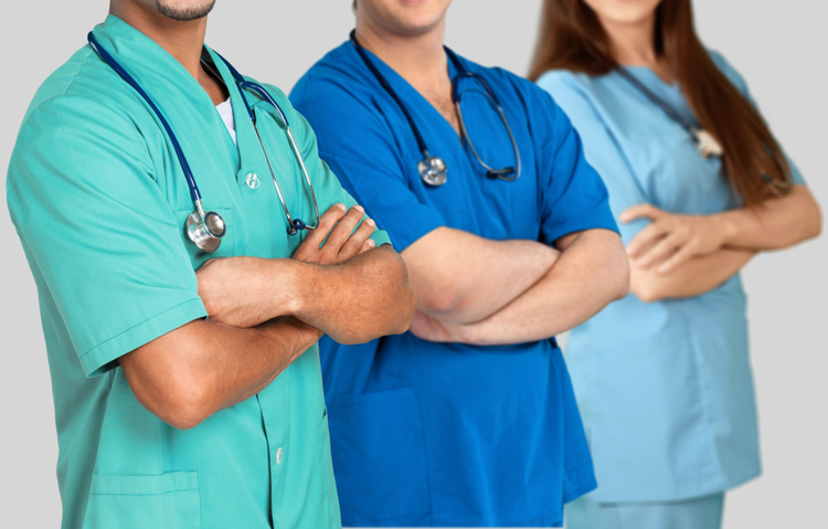 Three healthcare professionals wearing colorful medical uniforms and stethoscopes