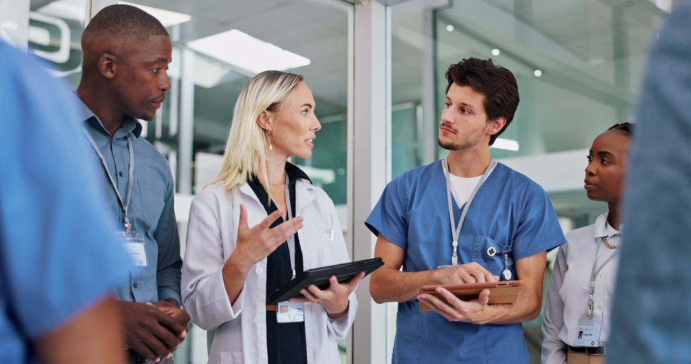Medical professionals in workwear having a discussion in a hospital setting