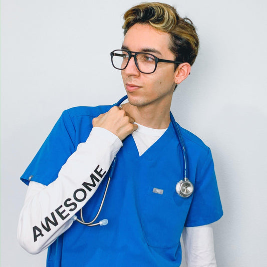 Navy blue MDF Instruments Acoustica® stethoscope with metal chest piece and flexible tubing, displayed in a professional healthcare setting.