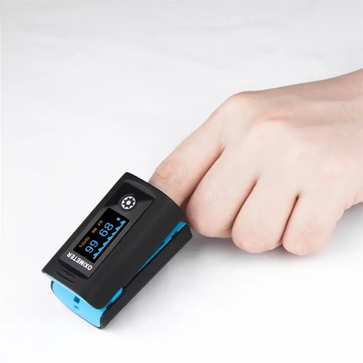 Finger pulse oximeter with digital display measuring blood oxygen on a person's finger